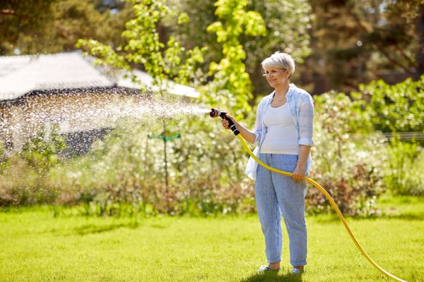 woman watering her yard