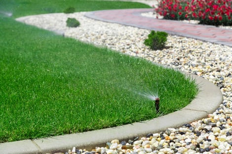 Sprinkler system in grass lawn