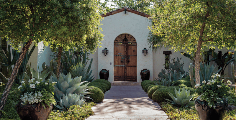Spanish home entry with lush garden design